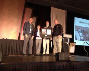 Tim McGuire and Phillip Michels, from Michels Corp., receive the 2015 Trenchless Technology Project of the Year New Installation award from Trenchless Technology editor Jim Rush and managing editor Sharon Bueno.