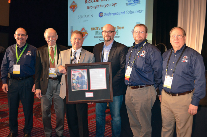 2015 Trenchless Technology Person of the Year Dan Liotti celebrates with his Midwest Mole crew and Trenchless Technology publisher Bernie Krzys.