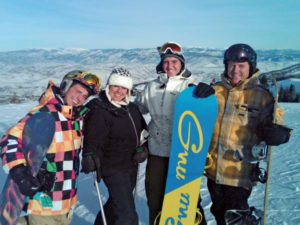 Dan and his wife of 27 years, Laura, with their sons Mike (left) and Brian (third from left) taking in some snowboarding in Park City, Utah.